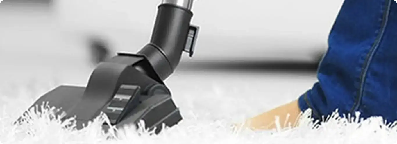 Close-up of a professional vacuuming a white carpet in Palo.